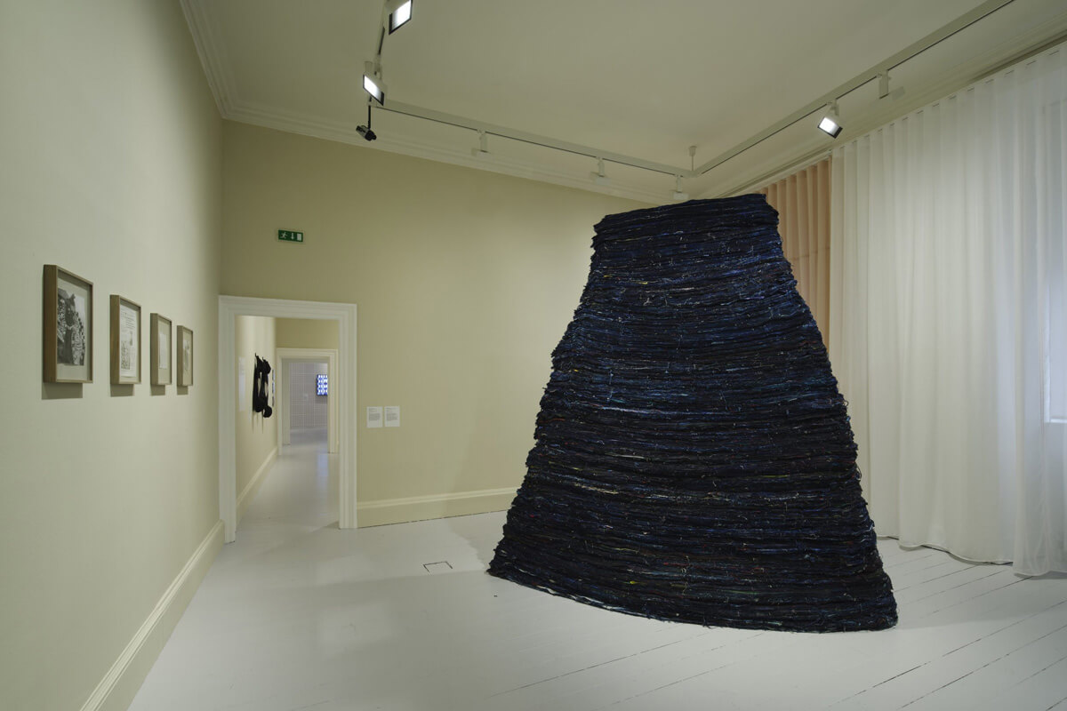 Installation view of Stack by Kathy Prendergast made from cloth, string, paint and wood.